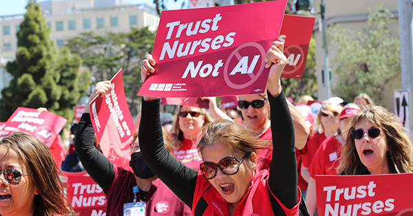 Nurses at rally, holding signd that say 