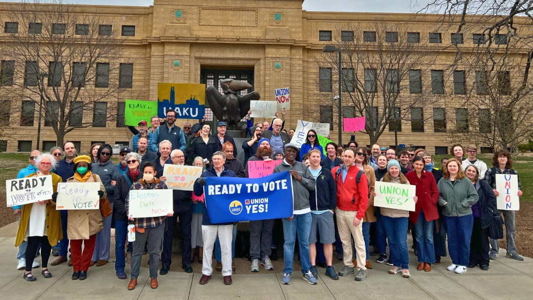 United Academics of the University of Kansas members pose with pro-union signs.