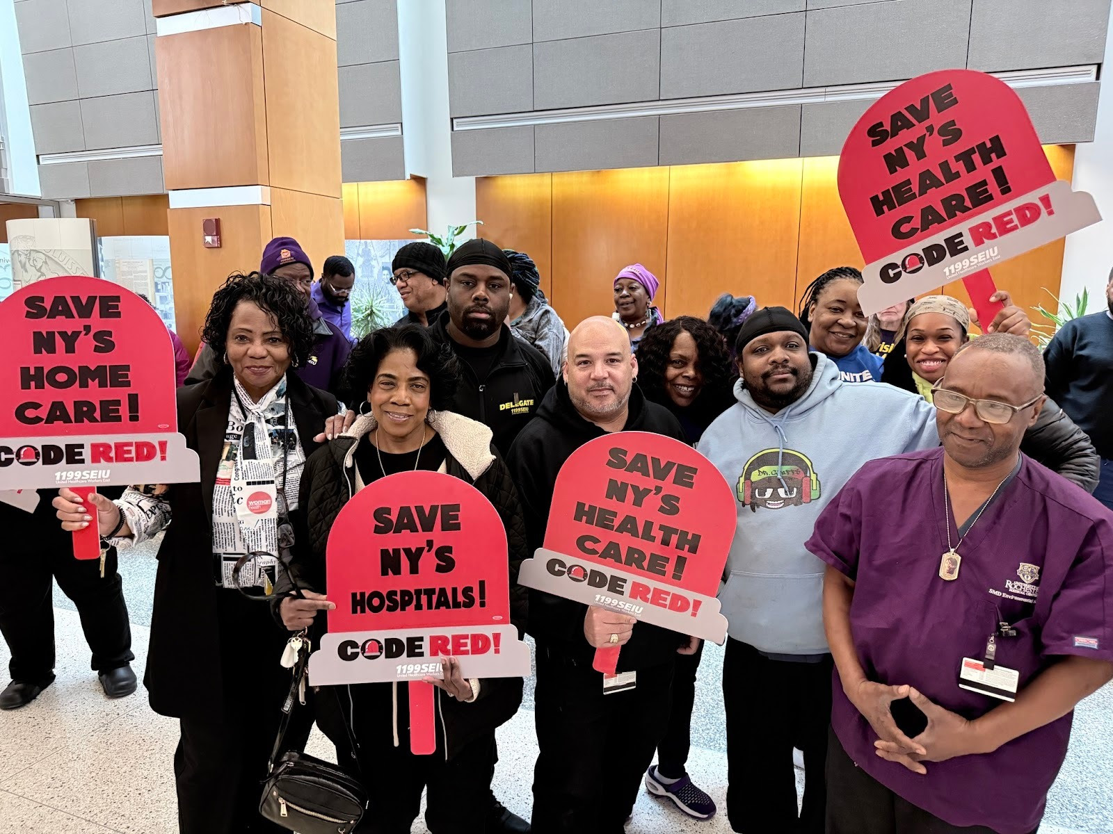 1199SEIU members holding signs that read, “Save NY’s home care,” “Save NY’s health care” and “Save NY’s hospitals!”