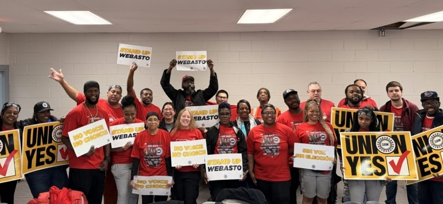 Webasto Detroit workers hold signs that read, “Union Yes,” “No voice, no choice” and “Stand up Webasto.”