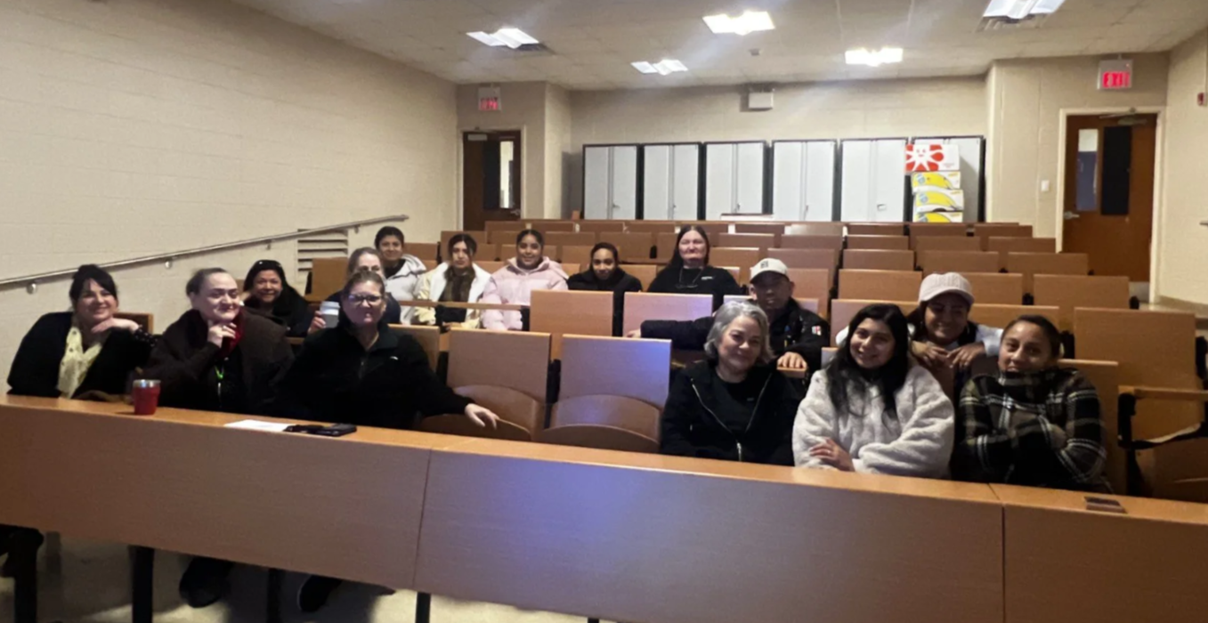 Members sitting in a small auditorium.