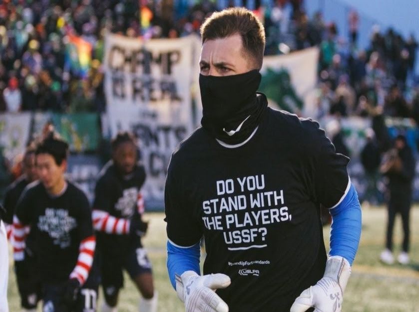 USLPA member wearing a shirt that reads, “Do you stand with the players, [United States Soccer Federation]?”